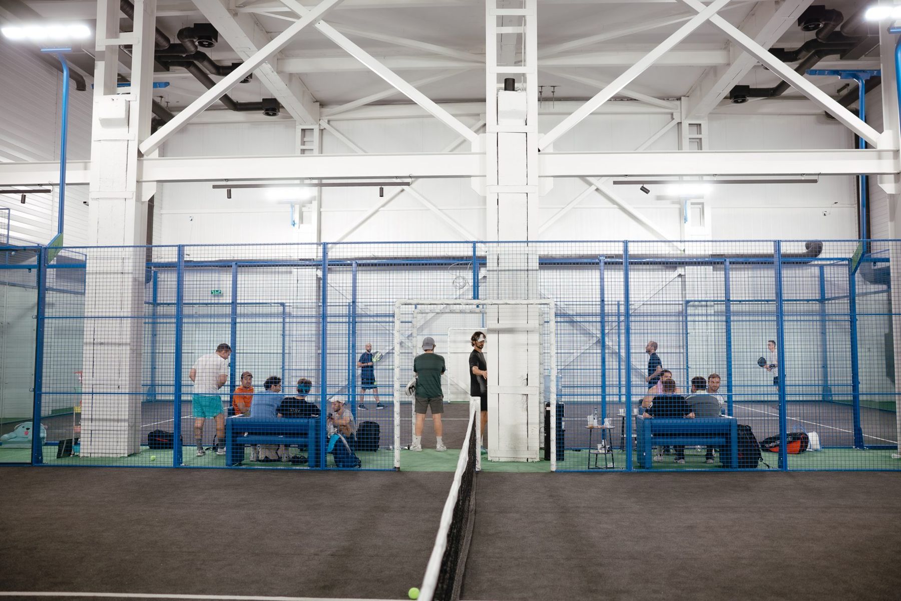 Players resting courtside on the indoor court